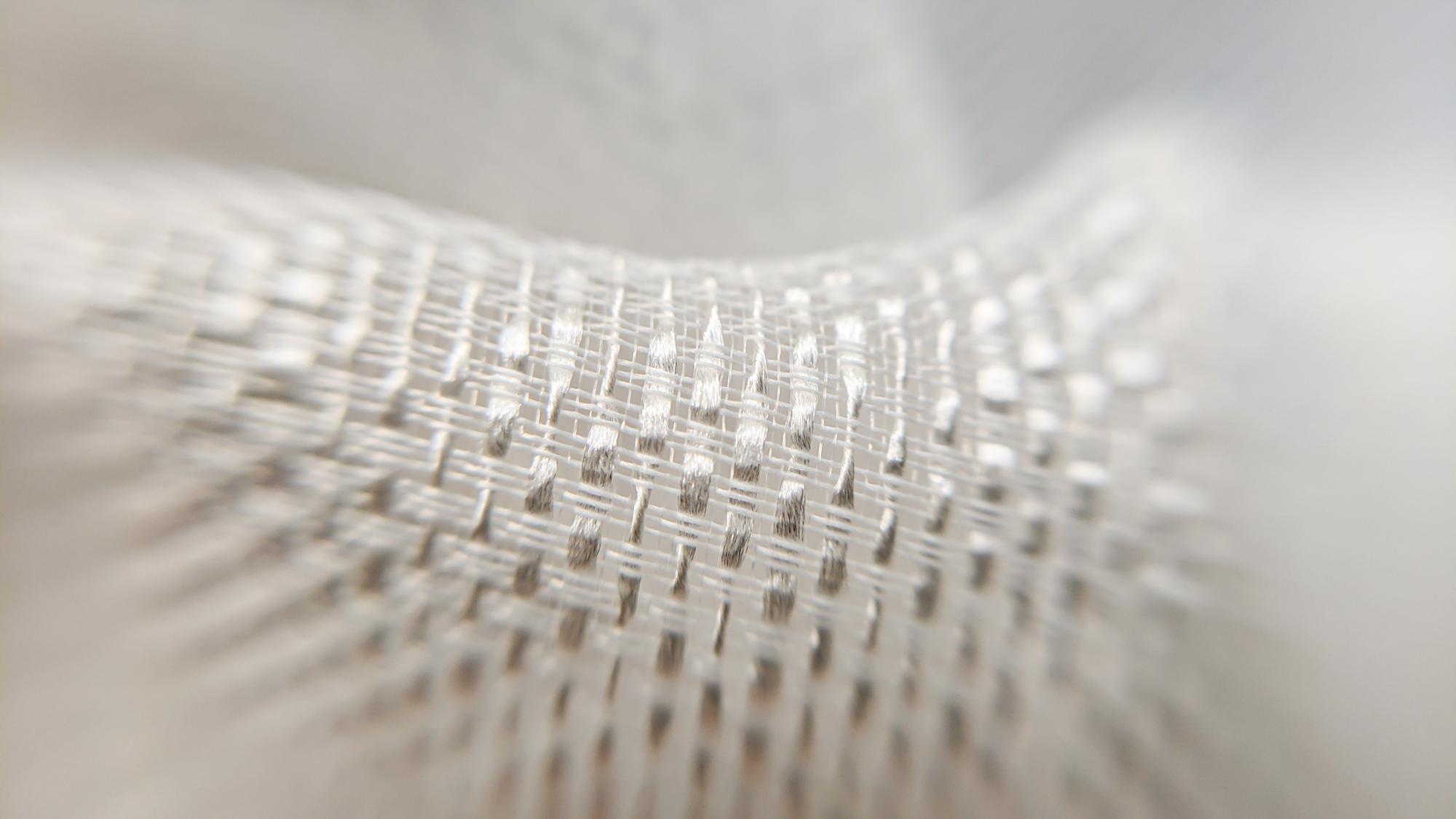 Close-up macro shot of thread texture and metallic highlights